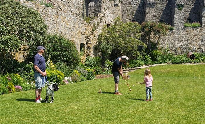 Visitors enjoying a game of croquet on the lawn